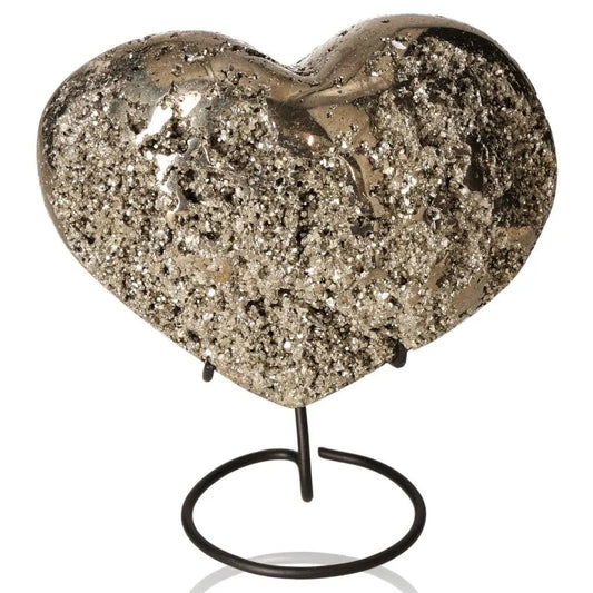 Heart-shaped pyrite stone with metallic luster on stand, symbolizing prosperity and abundance.