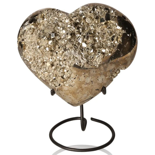Heart-shaped pyrite stone on a stand, showcasing its golden hue and metallic luster, symbolizing abundance and prosperity.