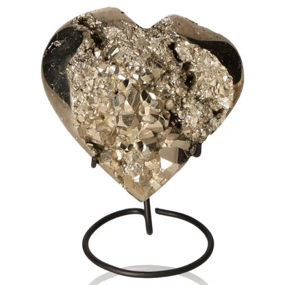 Heart-shaped pyrite stone with metallic luster on a stand, symbolizing abundance and prosperity, known as Fool's Gold.