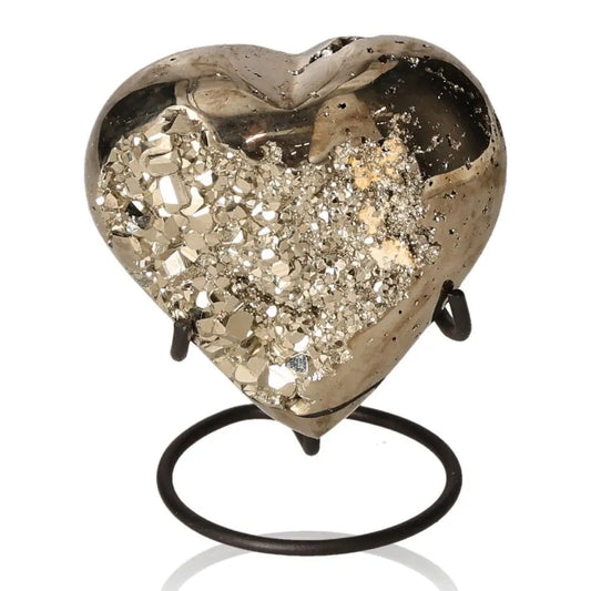 Heart-shaped pyrite mineral with metallic luster, symbolizing abundance and prosperity, displayed on a stand
