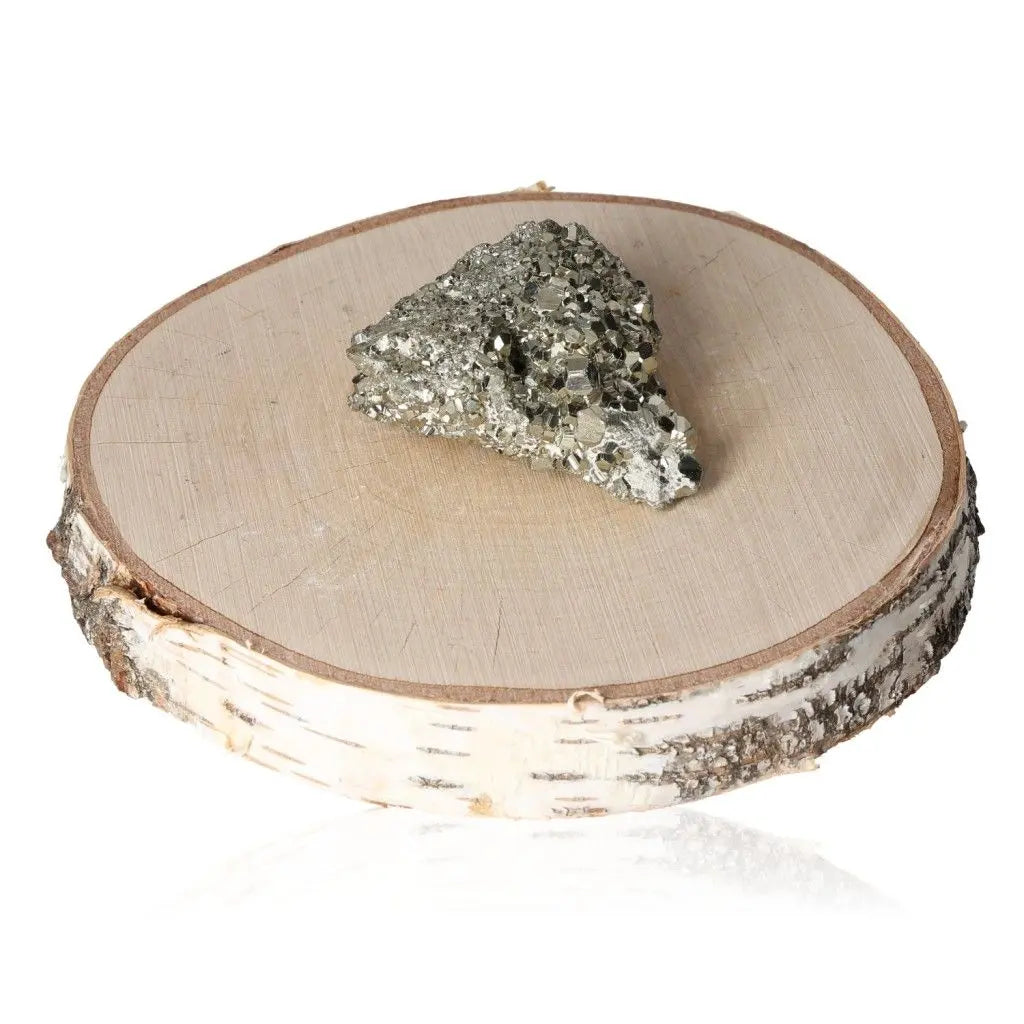 Pyrite druze displayed on a wooden slice, showcasing its golden hue and metallic luster, symbolizing wealth and prosperity.