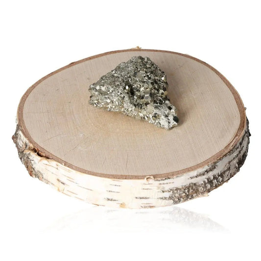 Pyrite druze displayed on a wooden slice, showcasing its golden hue and metallic luster, symbolizing wealth and prosperity.