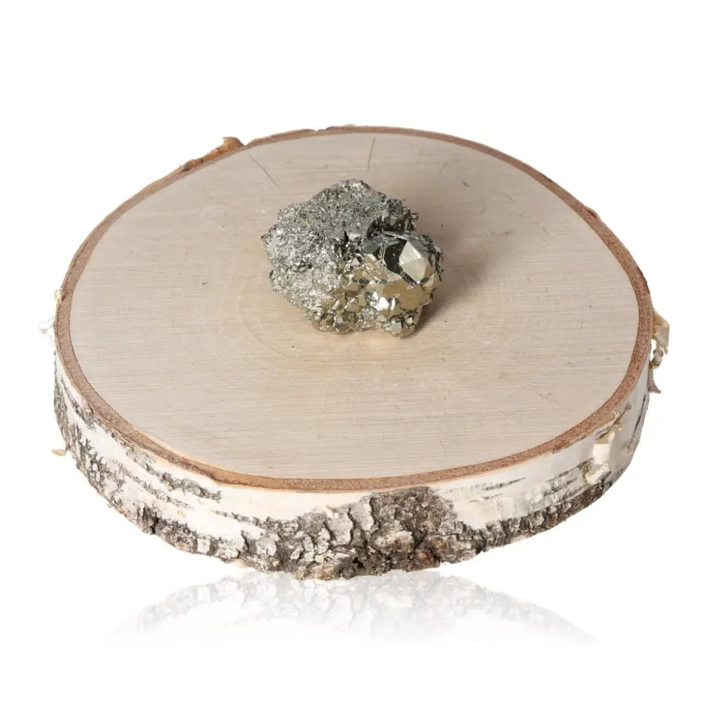 Pyrite druzy cluster on a wooden slab showcasing its golden hue and metallic luster, symbolizing abundance and prosperity.