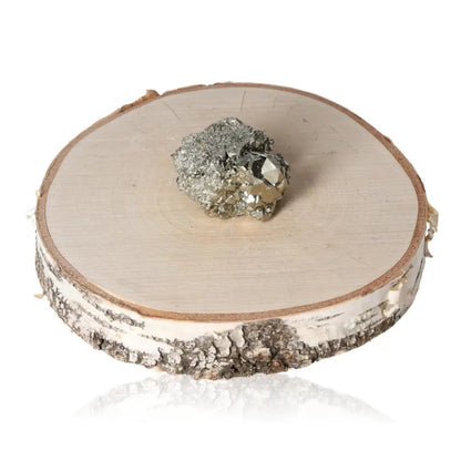 Pyrite druzy cluster on a wooden slab showcasing its golden hue and metallic luster, symbolizing abundance and prosperity.