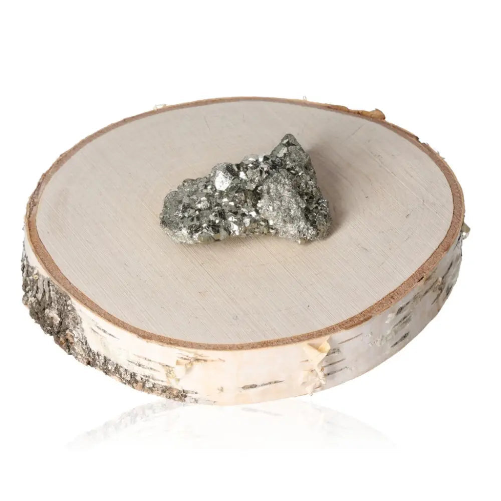 Pyrite druzy on a wooden slice, displaying metallic luster and golden hue, symbolic of abundance and prosperity.