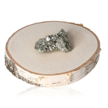 Pyrite druzy on a wooden slice, displaying metallic luster and golden hue, symbolic of abundance and prosperity.