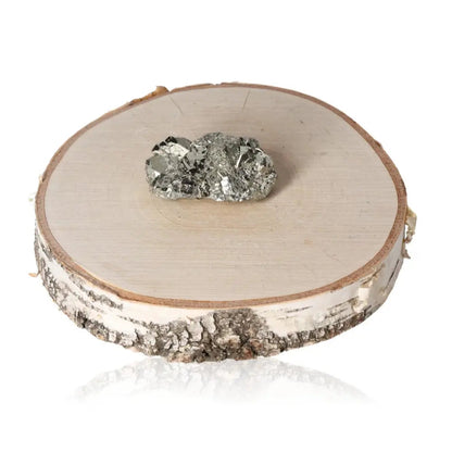 Pyrite druze on a wooden disc showcasing metallic luster, symbolizing wealth and abundance, often referred to as Fool's Gold.
