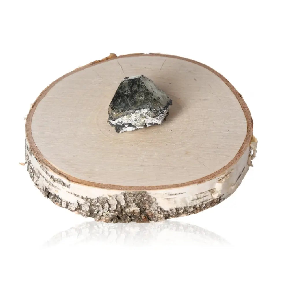 Pyrite druzy crystal placed on a natural wood slice, showcasing its metallic luster and golden hue, symbolizing abundance and prosperity.