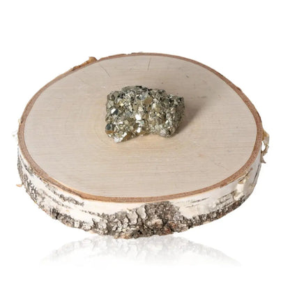 Pyrite druze with golden luster resting on a wooden slab, symbolizing prosperity and abundance.