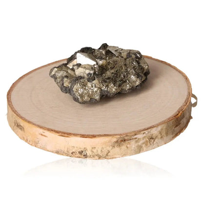 Pyrite druze placed on a round wooden slab, showcasing its golden hue and metallic luster.