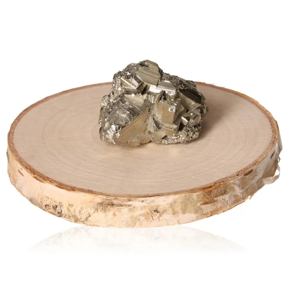 Pyrite druze stone with metallic luster on a wooden base, symbolizing abundance and prosperity.