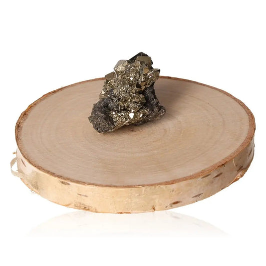 Pyrite druzy stone with metallic luster on wooden display, symbolizing wealth and prosperity.
