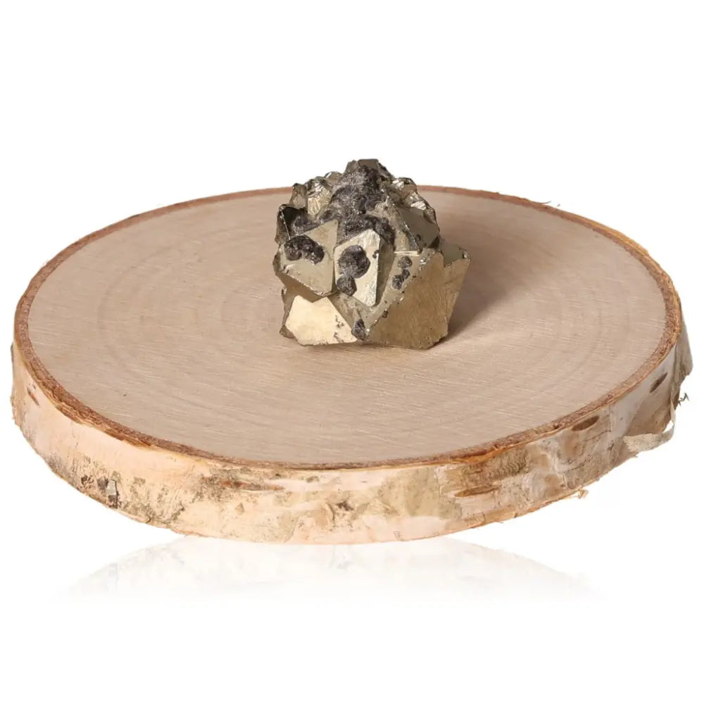 Pyrite druzy with metallic luster and golden hue on a wooden disc display, symbolizing abundance and prosperity.