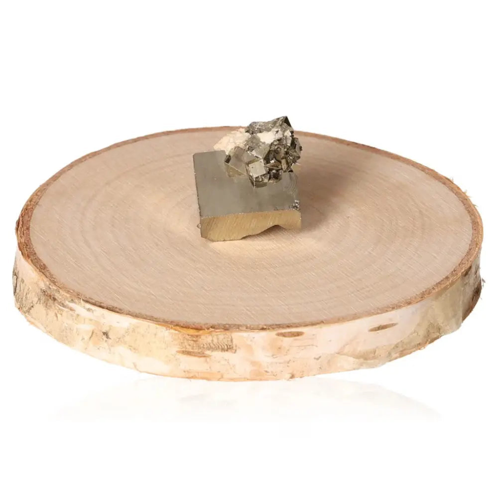 Pyrite druze on a wooden display, showcasing its golden hue and metallic luster, known as Fool's Gold, symbolizing abundance and prosperity.