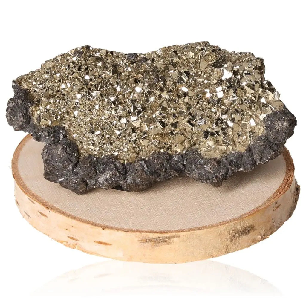 Pyrite druze mineral with brilliant golden hue and metallic luster on wooden base, known for wealth and prosperity symbolism.