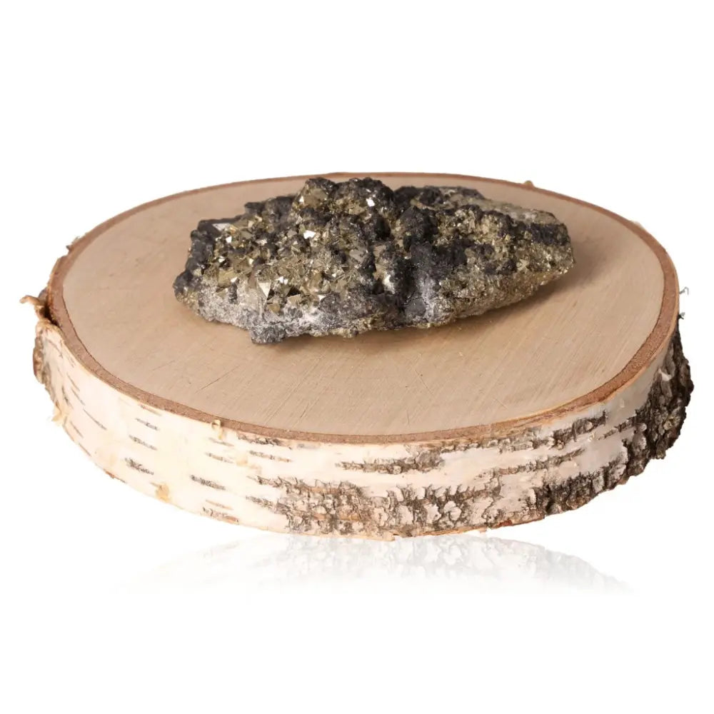 Pyrite druze on wooden slab showcasing its metallic luster and golden hue, known for attracting wealth and prosperity.