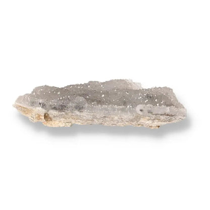 Detailed view of a Quartz gemstone showcasing its unique colors and texture, known for its captivating allure and energy harmonization.