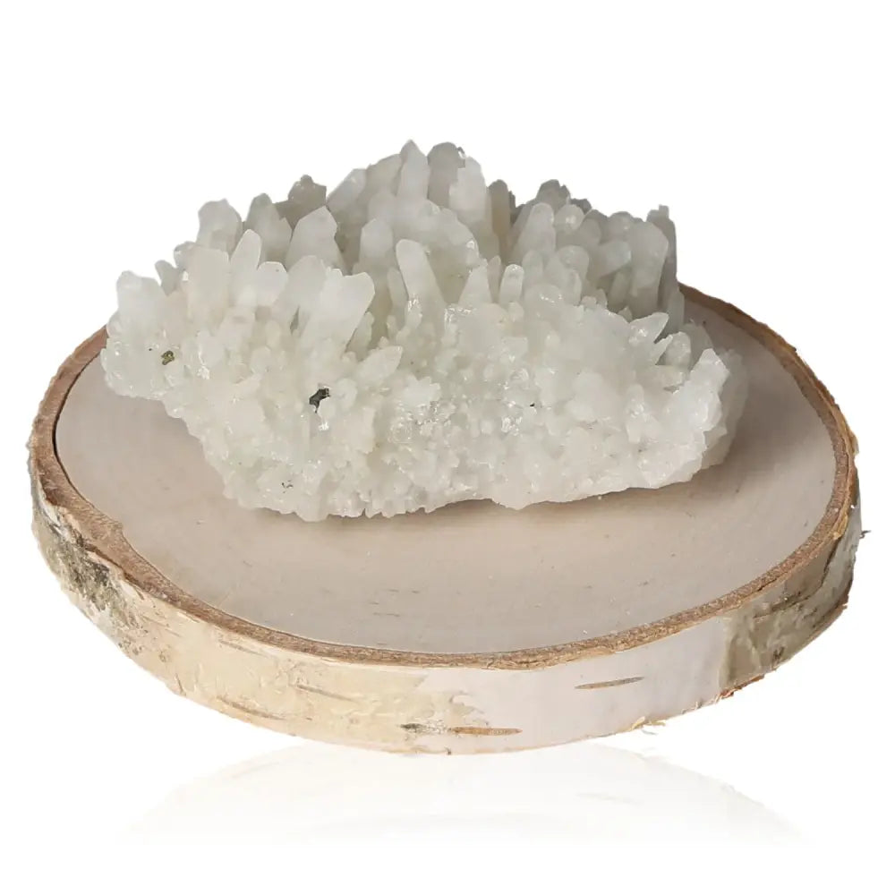 Quartz crystal cluster on wooden base showcasing natural beauty and spiritual significance in diverse color array.