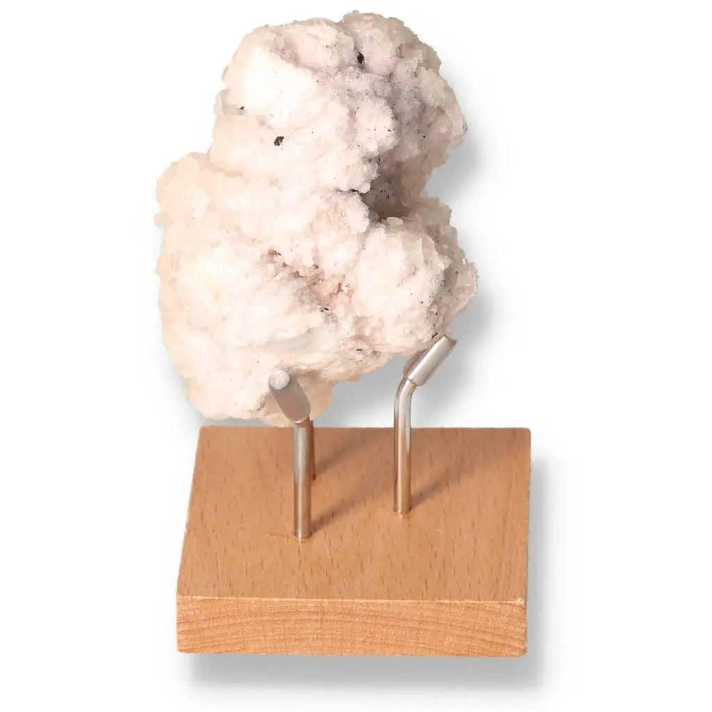 Quartz with Pink Halite on wooden stand, showcasing unique crystal textures and pink hues, perfect for spiritual balance and decor.