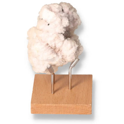 Quartz with Pink Halite on display stand offering energetic properties and spiritual harmony.