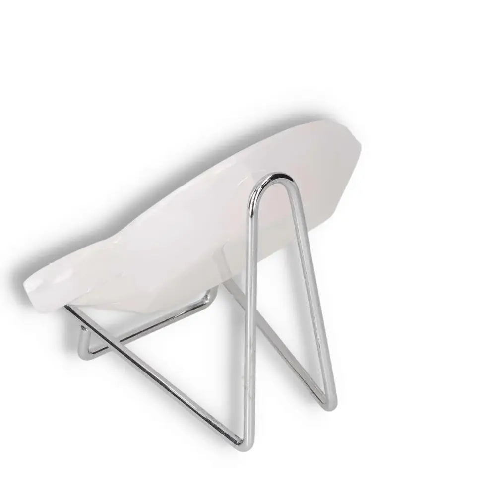 Modern white plate on a sleek silver stand, showcasing elegant design and minimalist style.