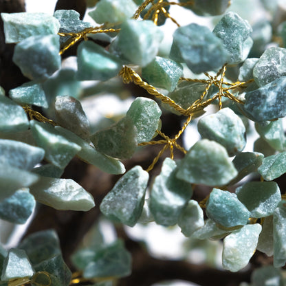 Close-up of green aventurine crystal bonsai tree showcasing intricately crafted rough stones for harmony and positive energy.