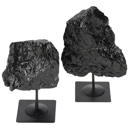 Rough black tourmaline on metal stand from Sylvia Crystals, known for protection and grounding energy, absorbs negative energies.