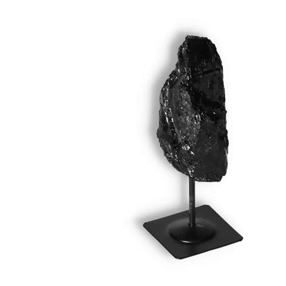 Rough Black Tourmaline on Metal Stand by Sylvia Crystals, known for cleansing negative energies, symbolizing conscious luxury and elegance.
