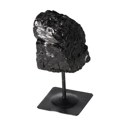 Rough Black Tourmaline on metal stand from Sylvia Crystals, known for cleansing and dispelling negative energies.