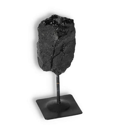Rough Black Tourmaline on Metal Stand S from Sylvia Crystals, known for cleansing negative energies and enhancing environments.