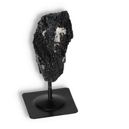 Rough Black Tourmaline on metal stand, premium quality crystal by Sylvia Crystals, known for cleansing and transforming negative energies.