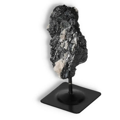 Rough Black Tourmaline with Metal Stand S from Sylvia Crystals, known for cleansing negative energies into positives.