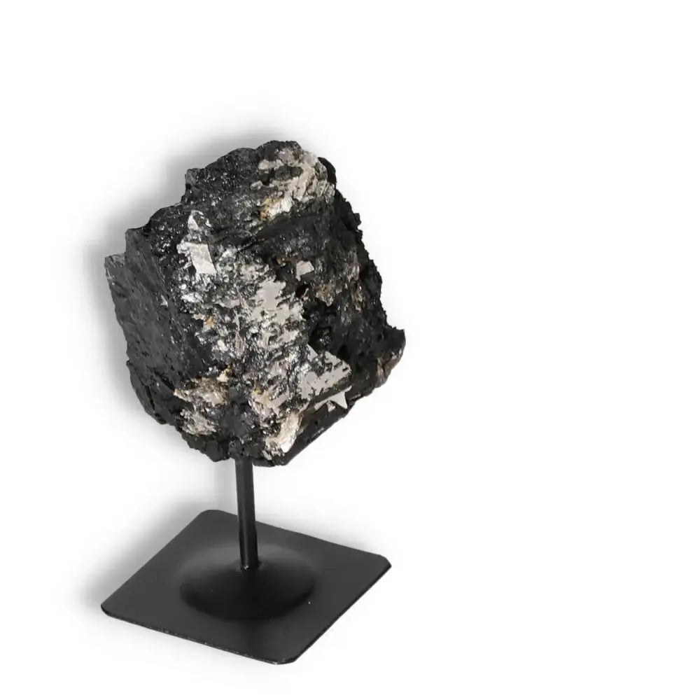Rough Black Tourmaline with Metal Stand S, known for transforming negative energies, from Sylvia Crystals. Premium quality.