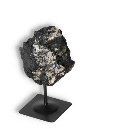 Rough Black Tourmaline with Metal Stand S, known for transforming negative energies, from Sylvia Crystals. Premium quality.