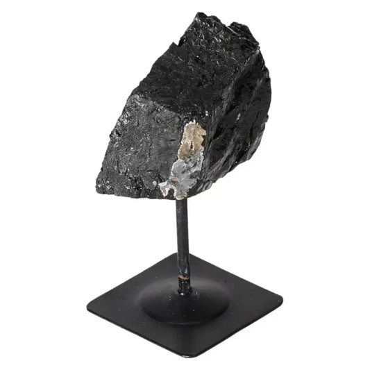 Rough Black Tourmaline crystal with metal stand from Sylvia Crystals, showcasing natural artistry and spiritual depth.