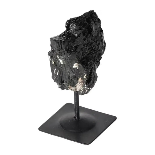 Rough Black Tourmaline on metal stand, showcasing natural beauty. Premium crystal from Sylvia Crystals for cleansing negative energies.