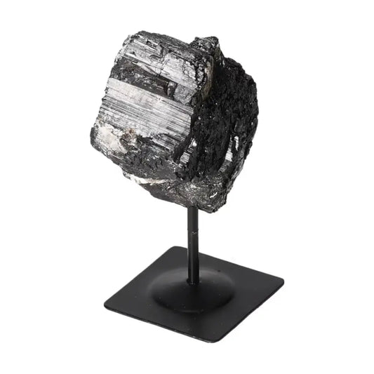 Rough Black Tourmaline on metal stand, premium gemstone for energy purification and grounding by Sylvia Crystals.