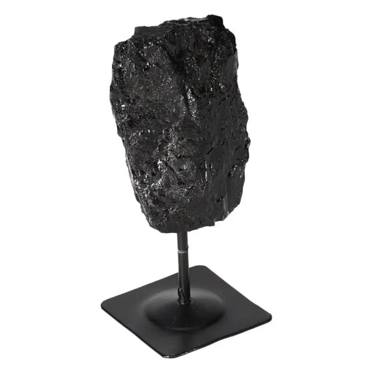 Rough Black Tourmaline on metal stand, offering powerful cleansing energy and grounding properties, ideal for promoting mental balance.
