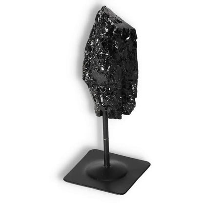 Rough Black Tourmaline with Metal Stand S by Sylvia Crystals, a powerful tool for dissipating negative energies and emotional healing.