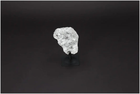 Rough Clear Quartz on Metal Stand by Sylvia Crystals, exhibiting natural beauty and luxury, known for purification properties.