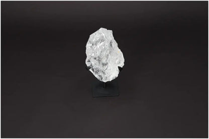 Rough Lemurian Clear Quartz Crystal on black metal stand for spiritual décor and purification, by Sylvia Crystals.