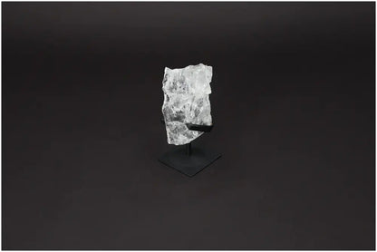 Rough Clear Quartz on metal stand showcasing its natural beauty and energy-boosting properties for mind and body harmony.