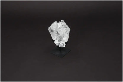 Rough Lemurian Quartz on metal stand by Sylvia Crystals, offering elegance and spiritual purity against a dark background.