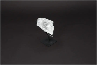 Rough Lemurian Quartz on metal stand, showcased on a dark background, highlighting its clear crystal structure, luxury, and elegance.