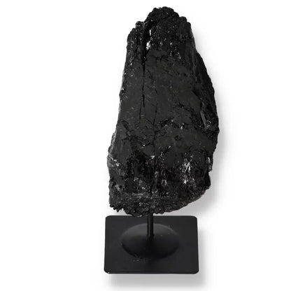 Rough Tourmaline Crystal on Metal Stand, showcasing natural black hues, by Sylvia Crystals for energy harmonization and luxury decor.