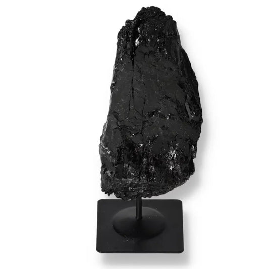 Rough Tourmaline Crystal on Metal Stand, showcasing natural black hues, by Sylvia Crystals for energy harmonization and luxury decor.