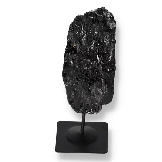 Black Rough Tourmaline on Metal Stand, showcasing its natural texture and unique energy properties for home decor by Sylvia Crystals.