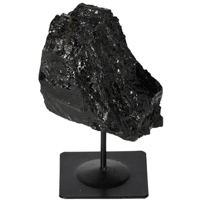 Rough tourmaline crystal on a metal stand, showcasing its natural deep black hues and energy-balancing properties.