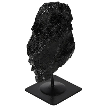 Rough black tourmaline on metal stand, premium decor piece by Sylvia Crystals, showcasing natural energy-balancing qualities.