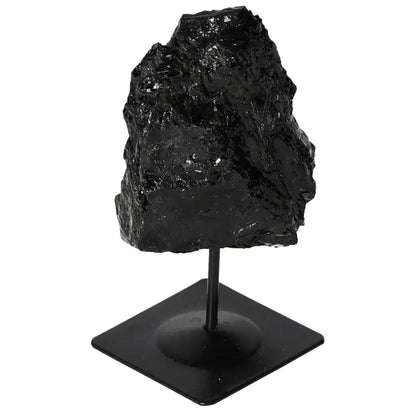 Rough tourmaline crystal on metal stand, showcasing deep black hues and natural textures. Ideal for home decor and energy balancing.